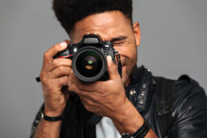 Close-up photo of concentrated afro american man taking photo on